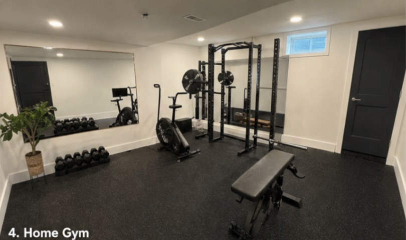 Basement home gym with squat rack, dumbbells, and mirrored wall