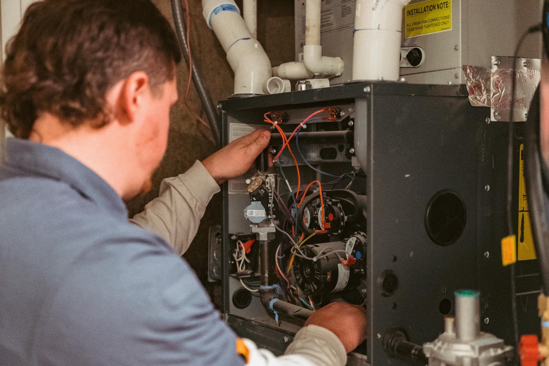 All Systems Go technician performing a furnace tune-up in a Utah home
