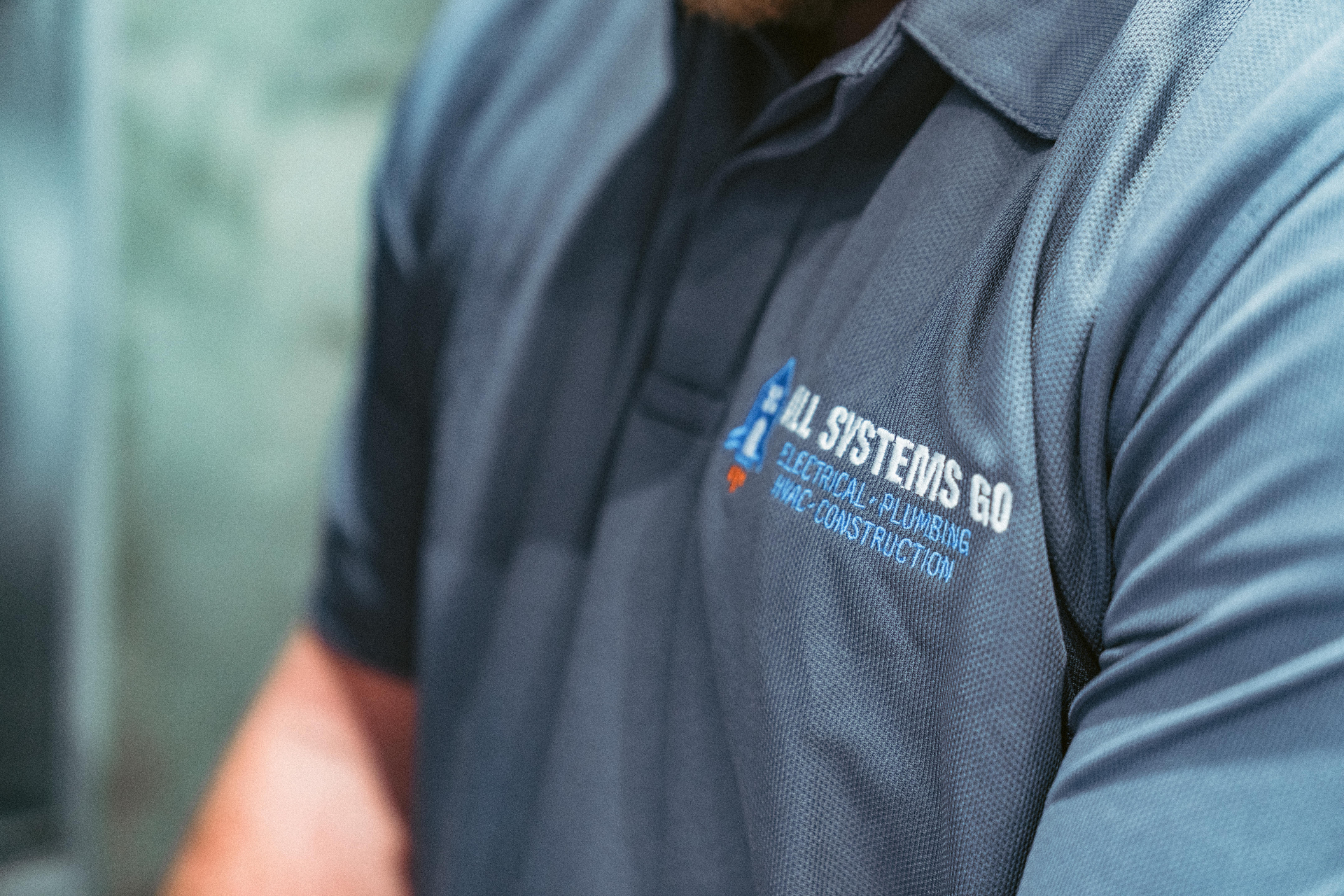 All Systems Go team member in branded polo