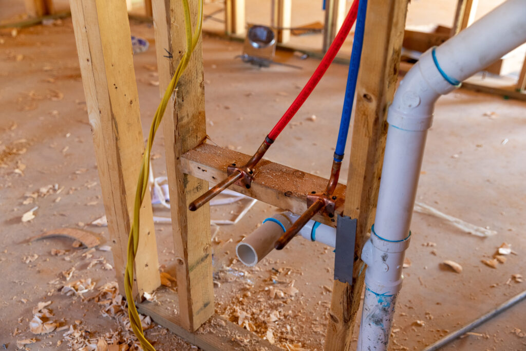 PEX plumbing and PVC pipe drain in new home construction